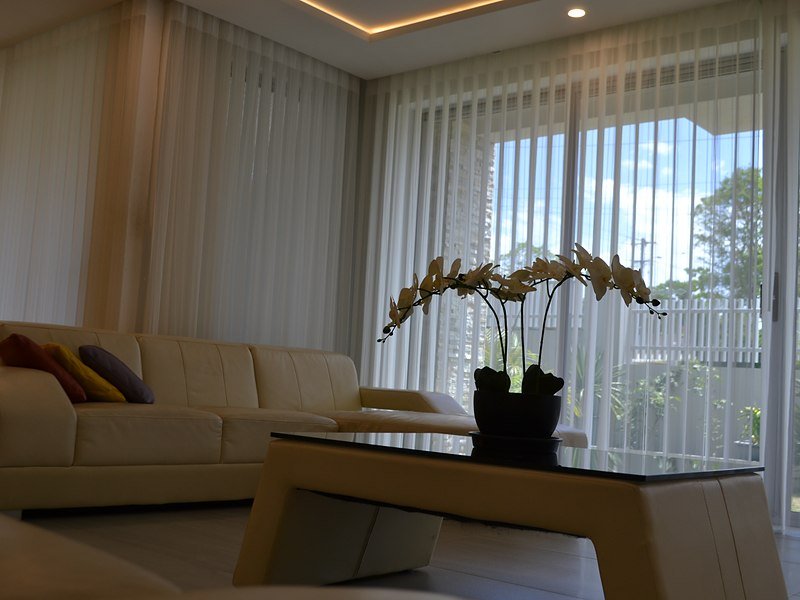 Sheer S-fold curtains framing a sunlit Perth living room