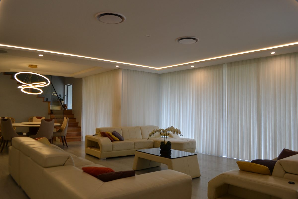 Floor-to-ceiling sheer curtains in a calm, light-filled room